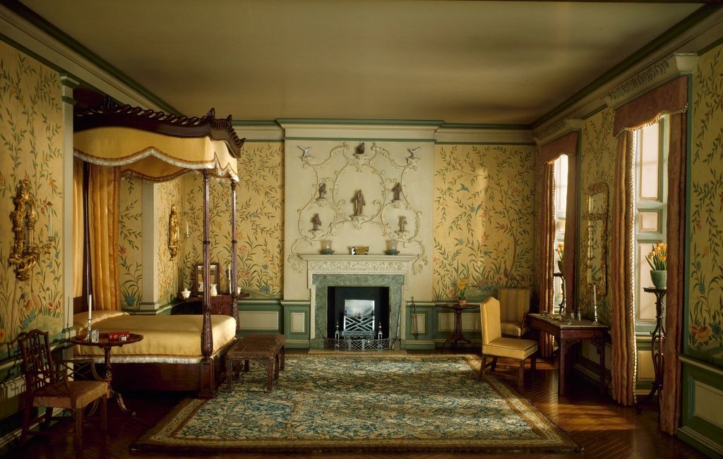 A guest room with a large bed and soft lighting